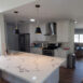 Kitchen remodel with white countertop and cabinets.