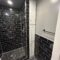 A finished black and white bathroom done by In him construction.