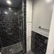 A finished black and white bathroom done by In him construction.